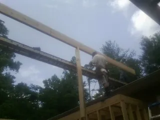 Carpenter setting a ridge beam over a new addition frame — Ice Dam Removal by Roofing Brothers in Terre Hill