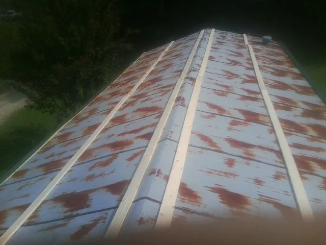 Rusted metal roof panels with new wood purlins before replacement — Storm Damage Roof Repair in Terre Hill by Roofing Brothers