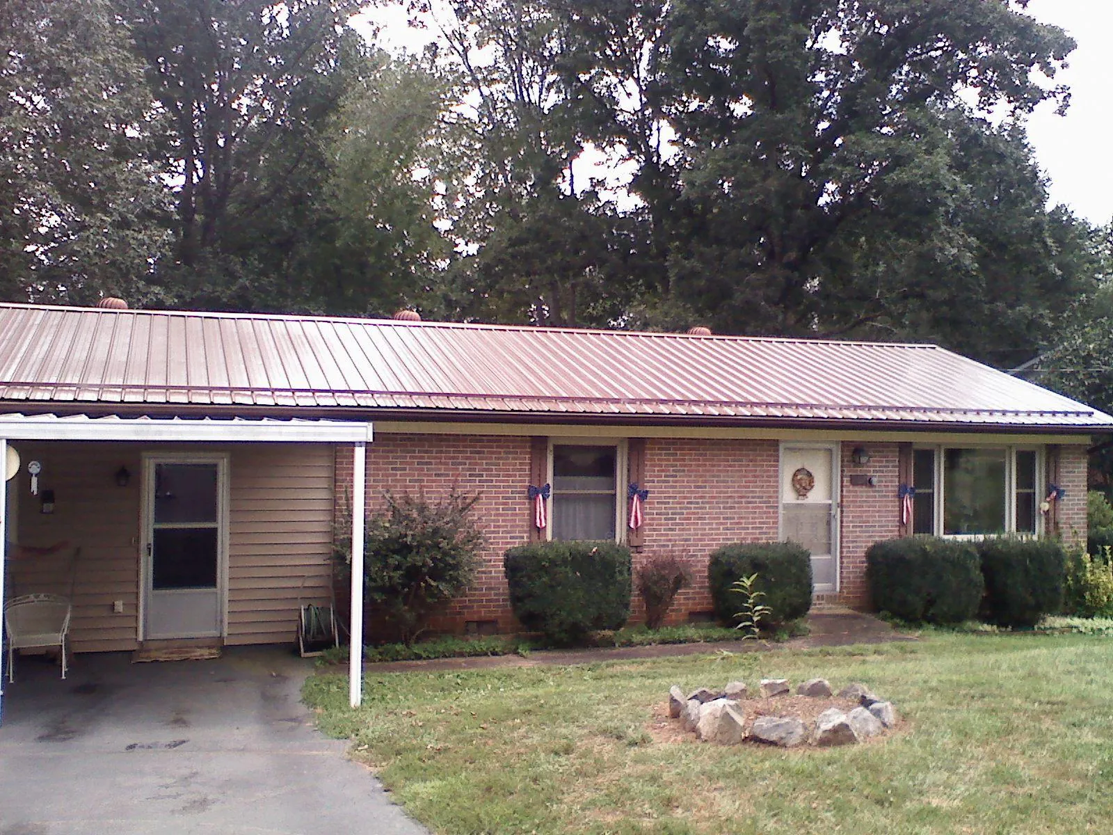 Bronze metal roof and carport on a brick ranch home — Roof Repair work by our crew in Terre Hill